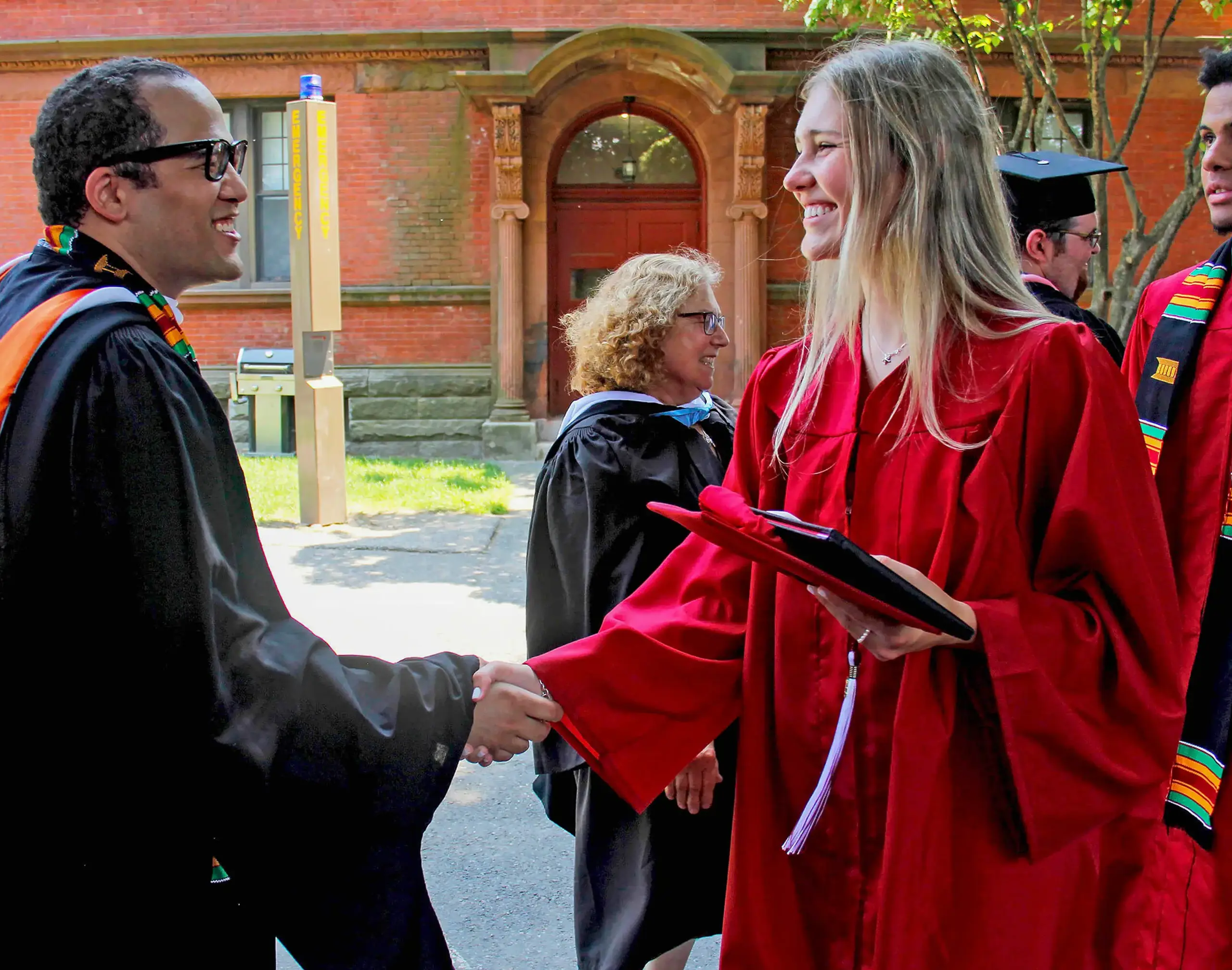 Teacher and student shake hands at Graduation 2024.