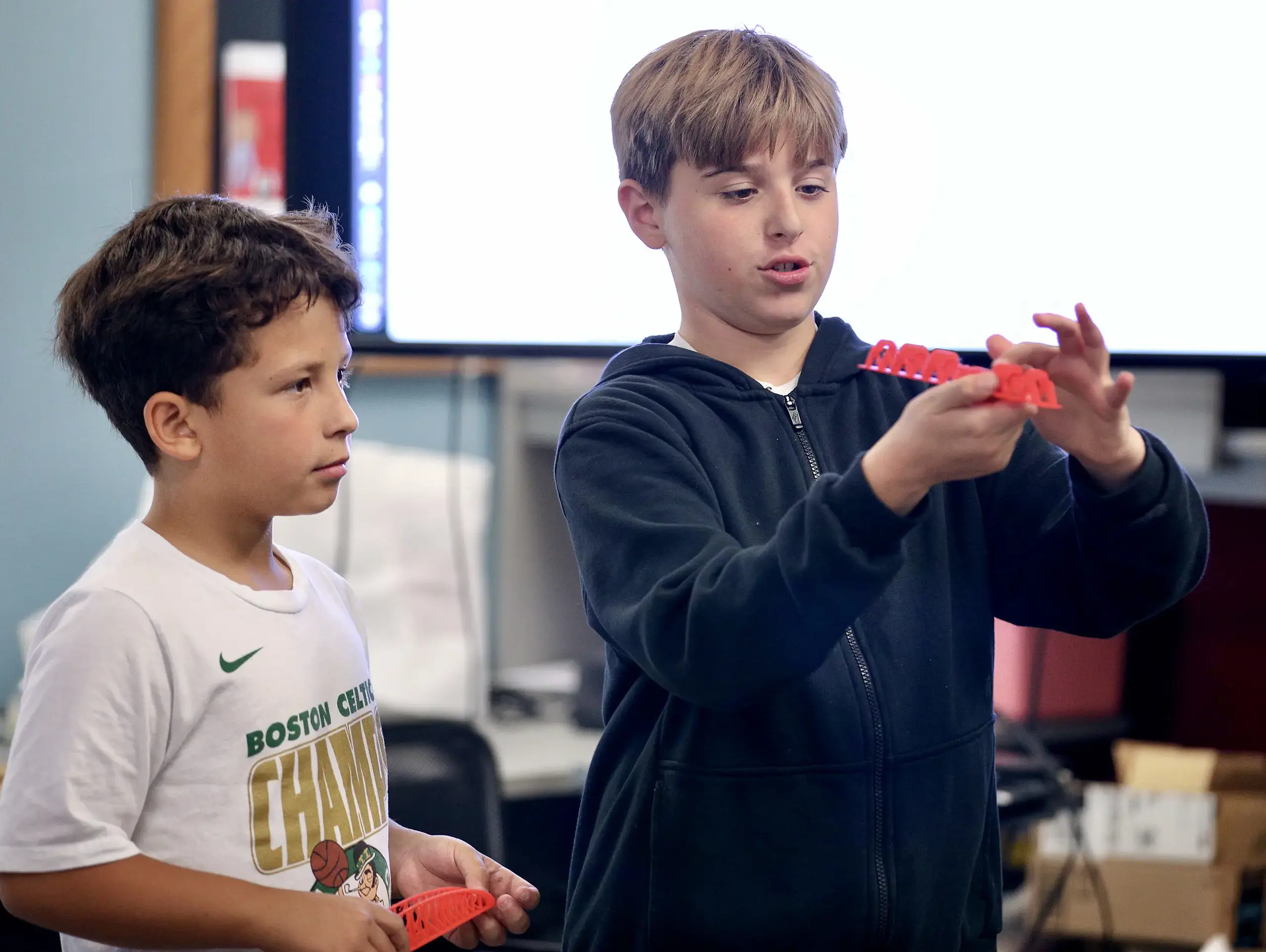 Two Middle School students in a Bridge Project class presenting their bridges.