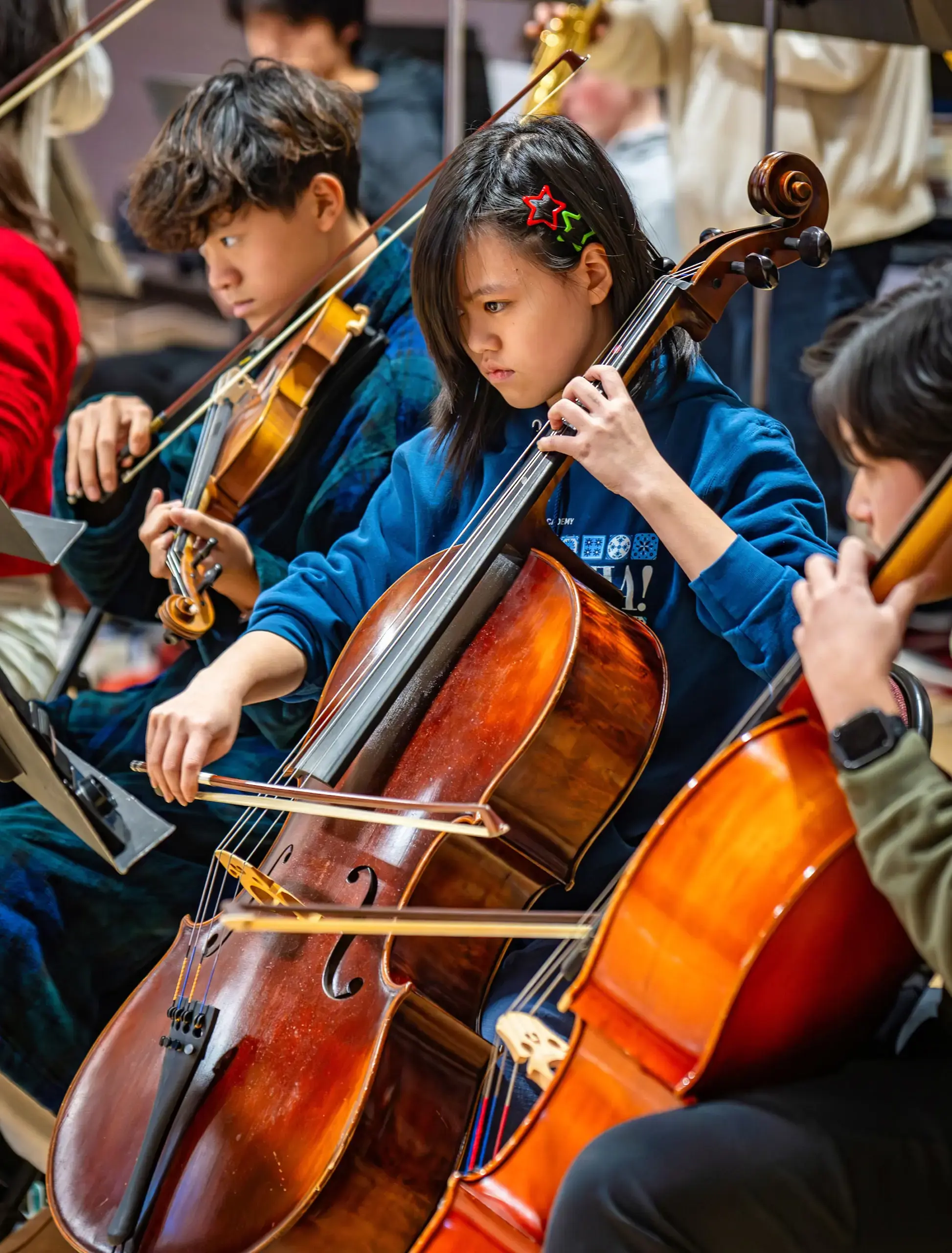 Student playing cello at a holiday concert.