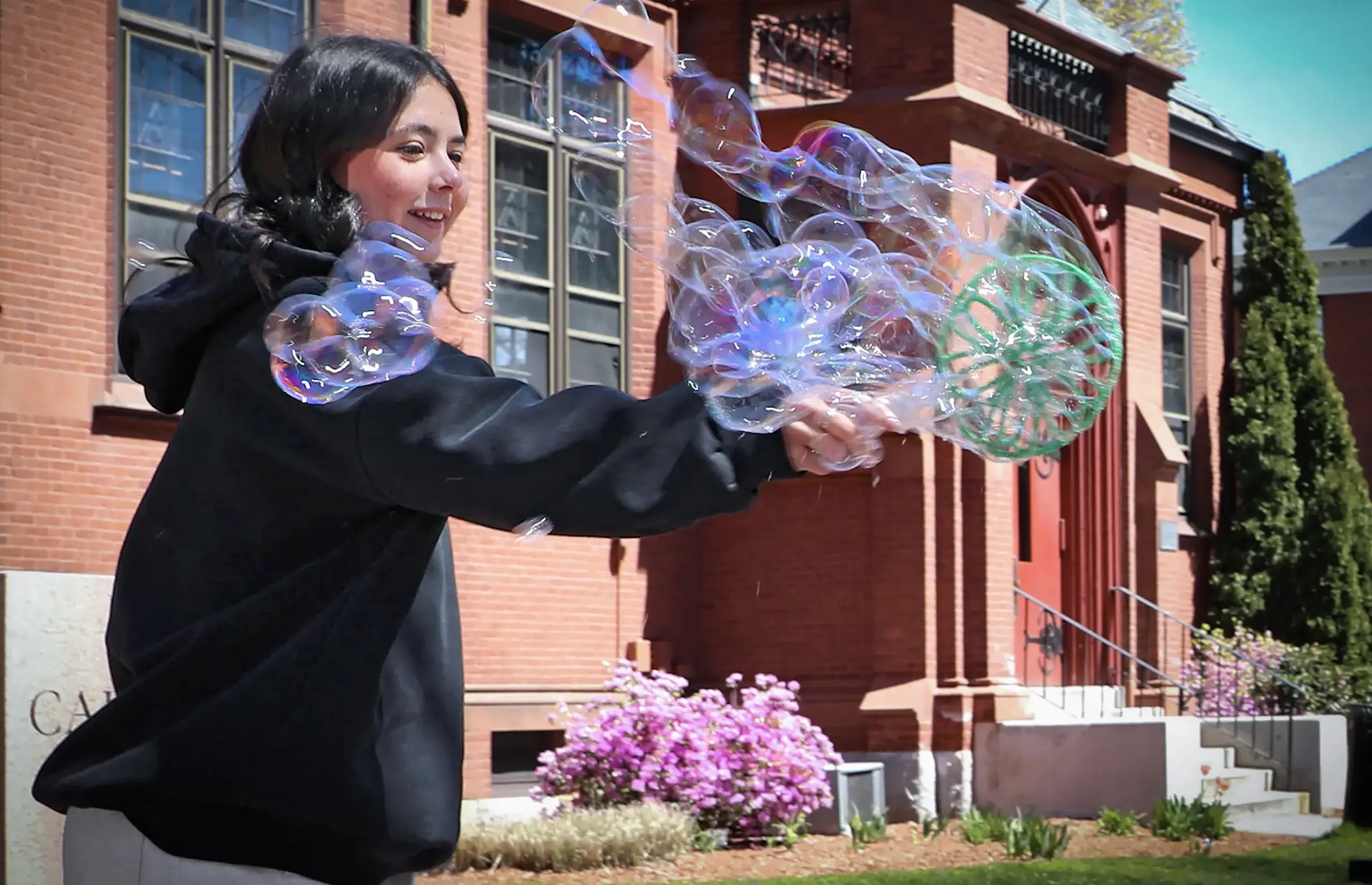 Girl outside with large bubbles