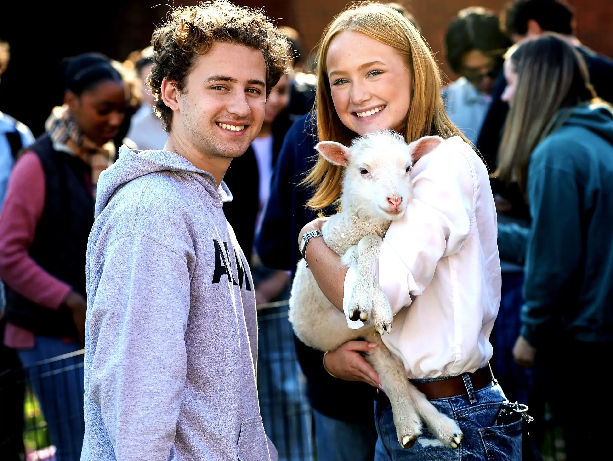 Worcester Academy Upper School students with a baby goat for wellness day.