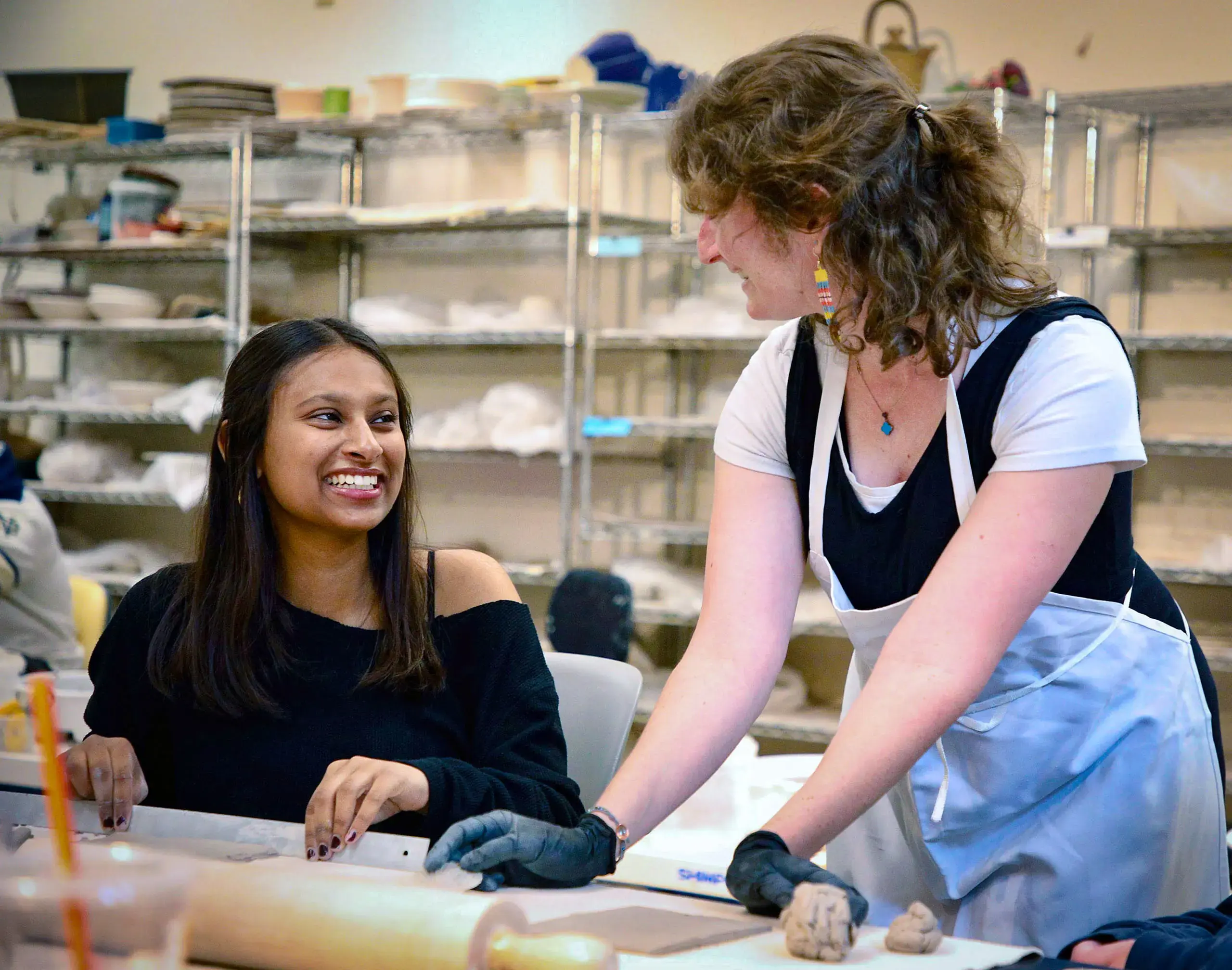 Upper School student with art teacher ceramics class