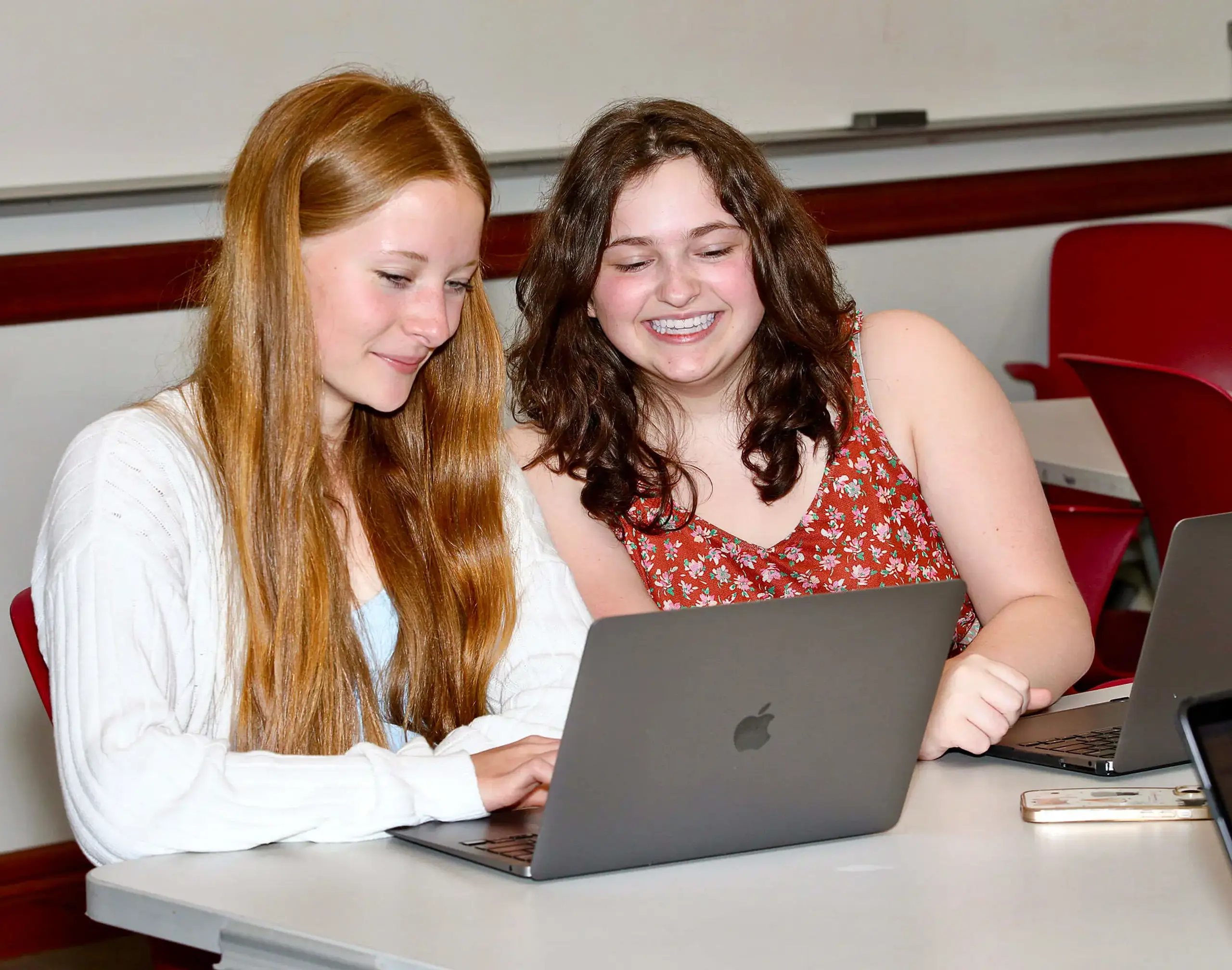 Worcester Academy Students doing classwork together on a laptop