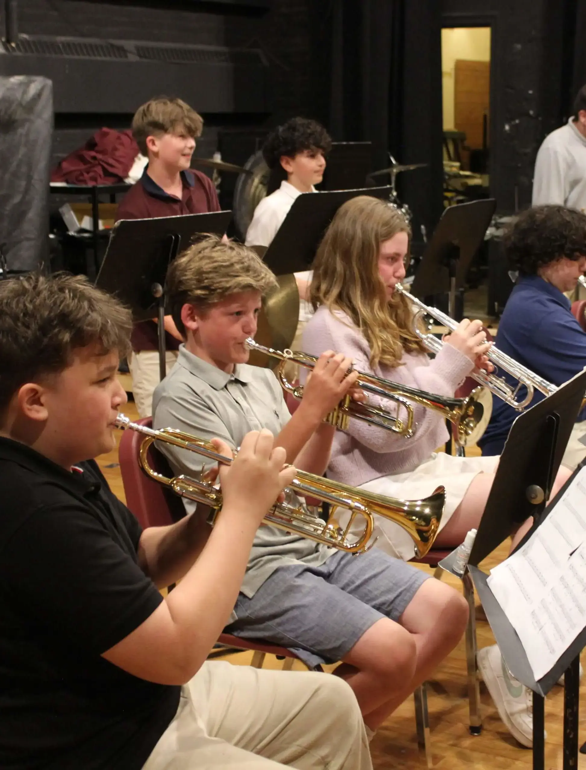 Worcester Academy Middle School student brass players performing with an orchestra.