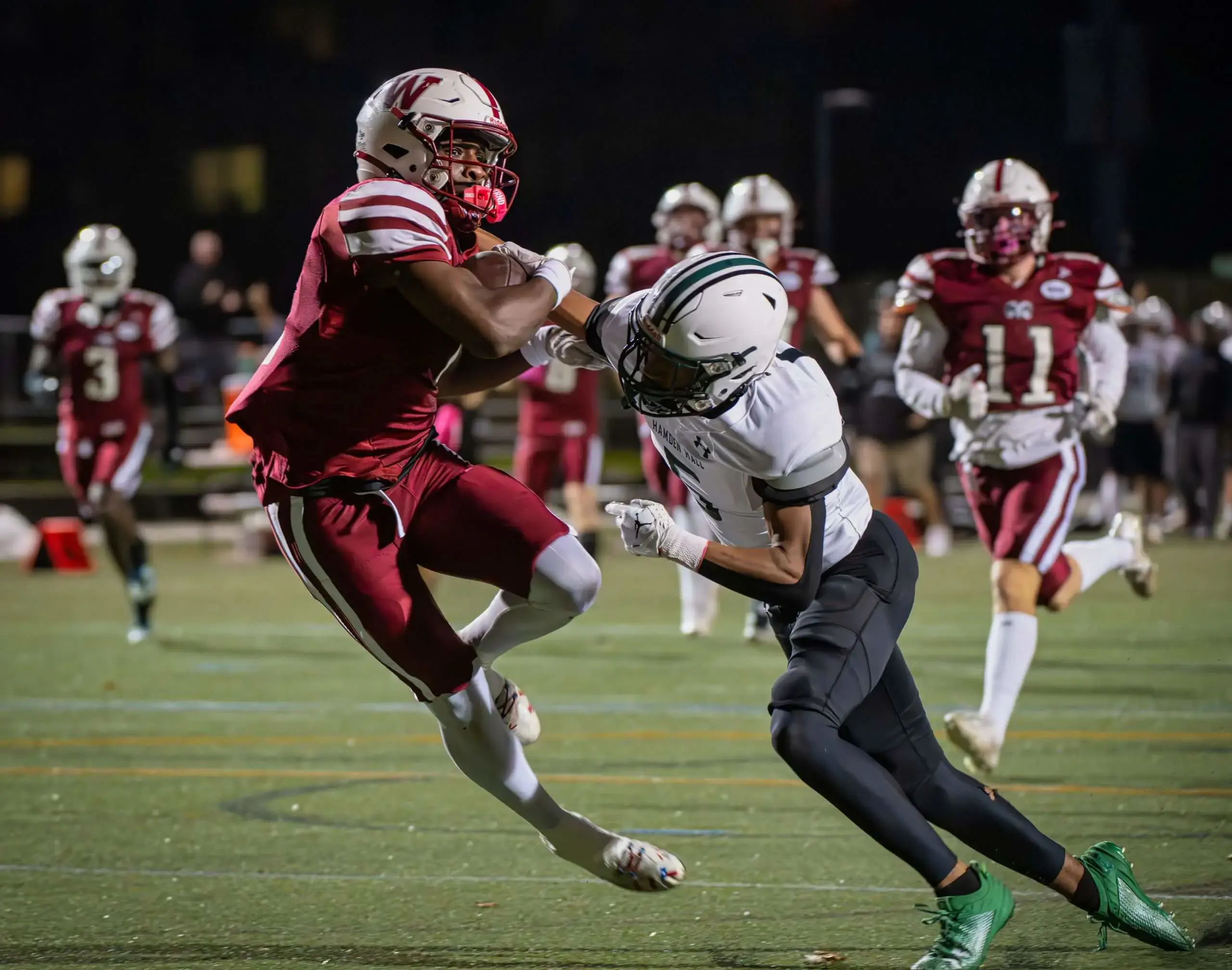 Worcester Academy Football plays in a match being tackled by opponent