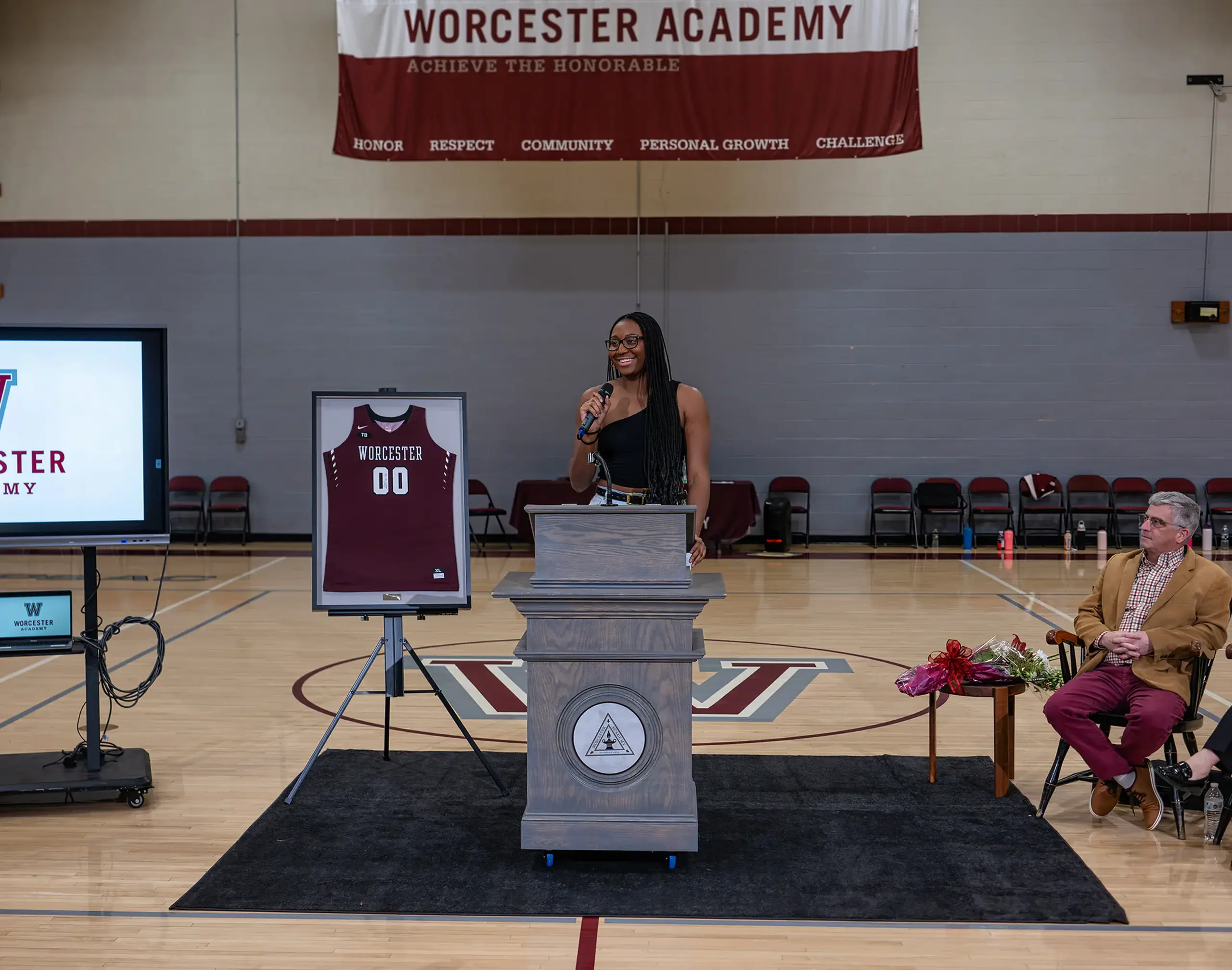 Alumni speaking at an award ceremony.