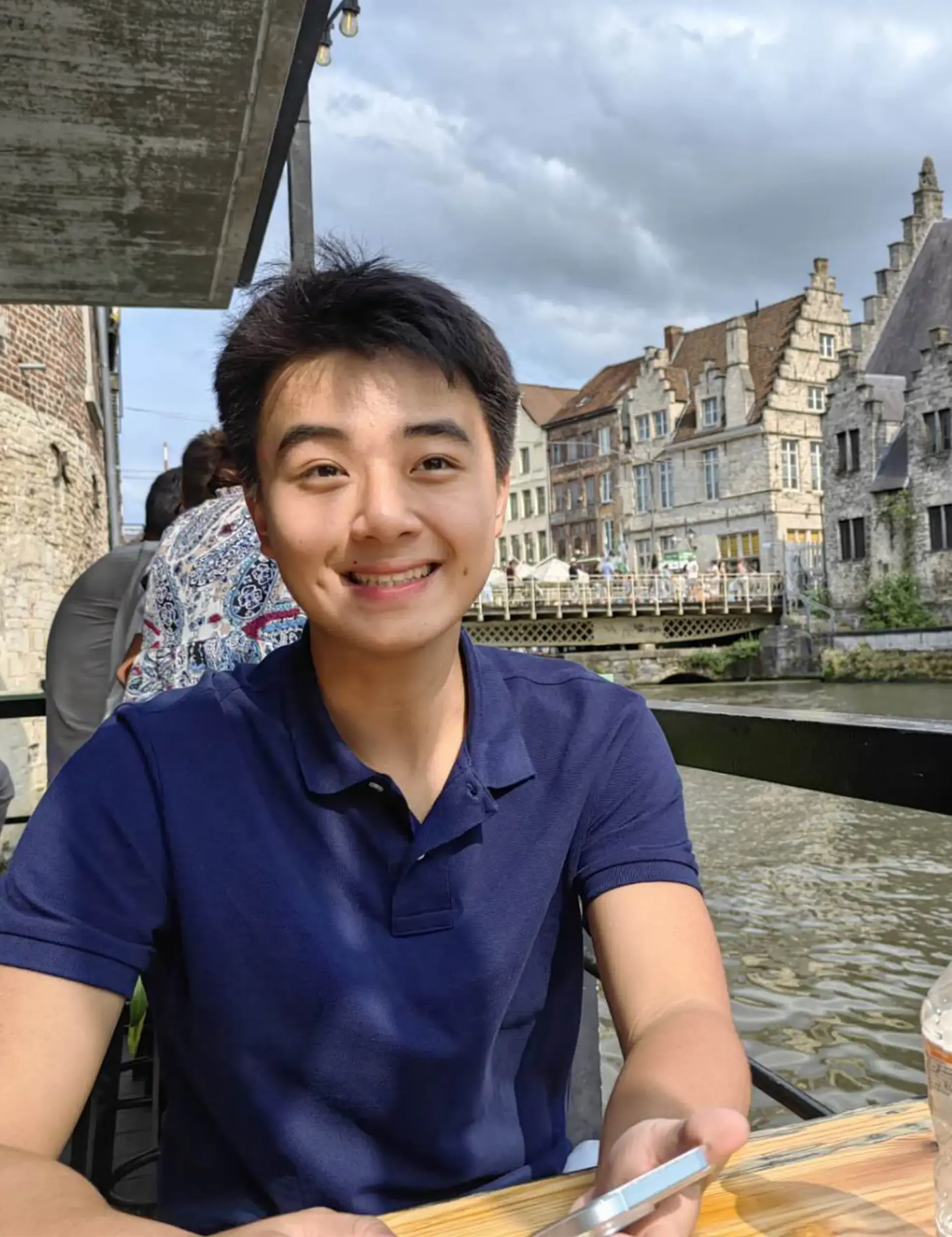 Harry Luo ’26 in Europe with a river in the background.