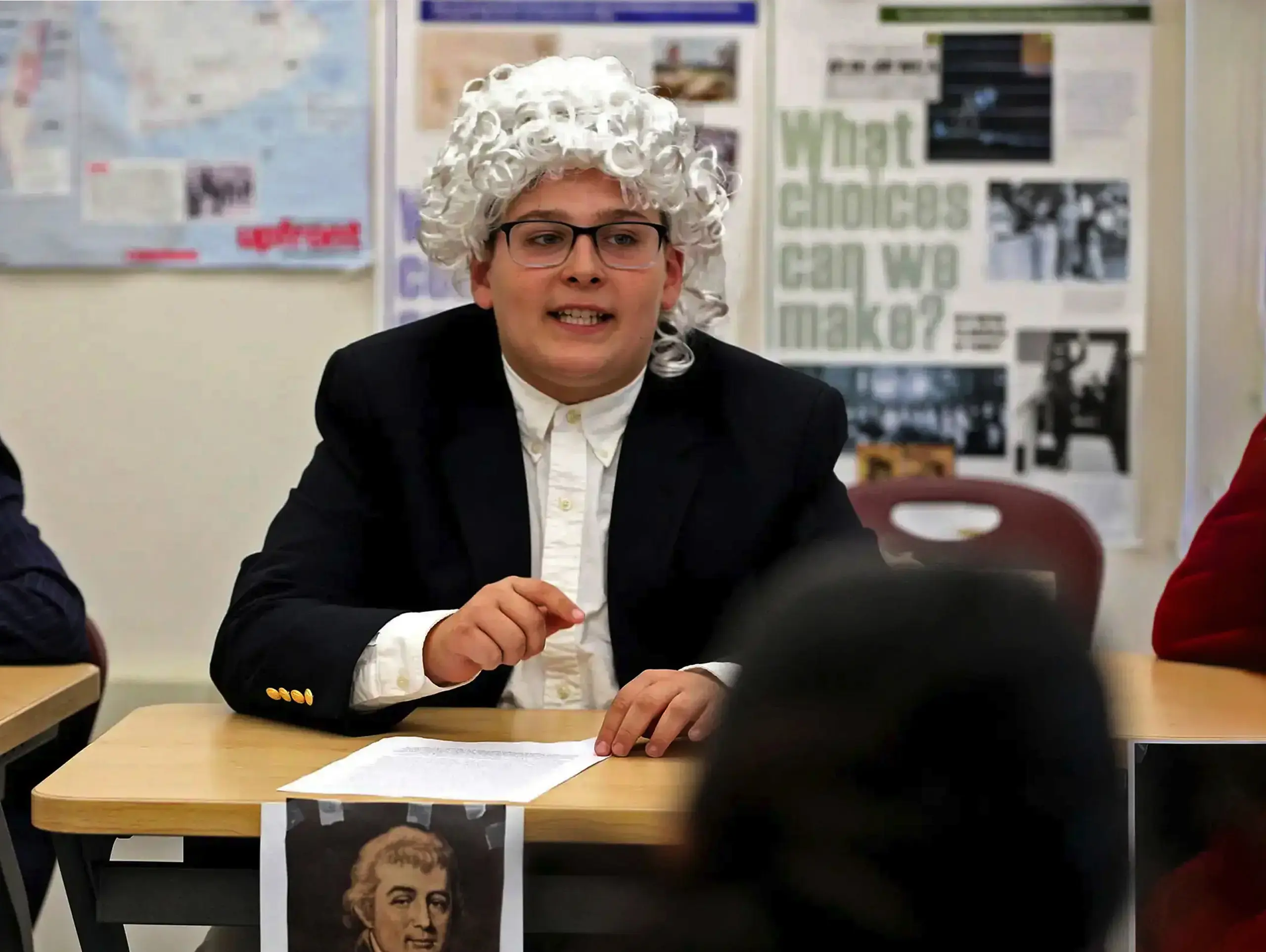 Middle School student in period clothing and wig in the classroom learning about the Constitution.