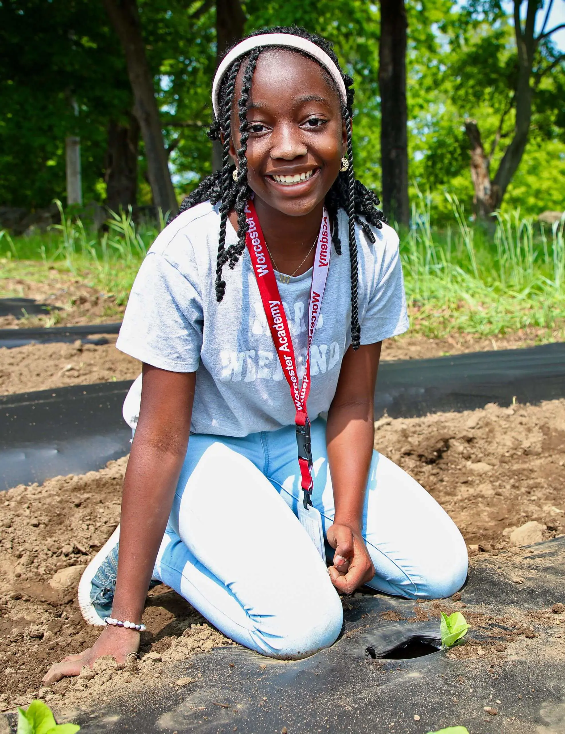 Worcester Academy Middle School student Planting seeds for hunger relief.