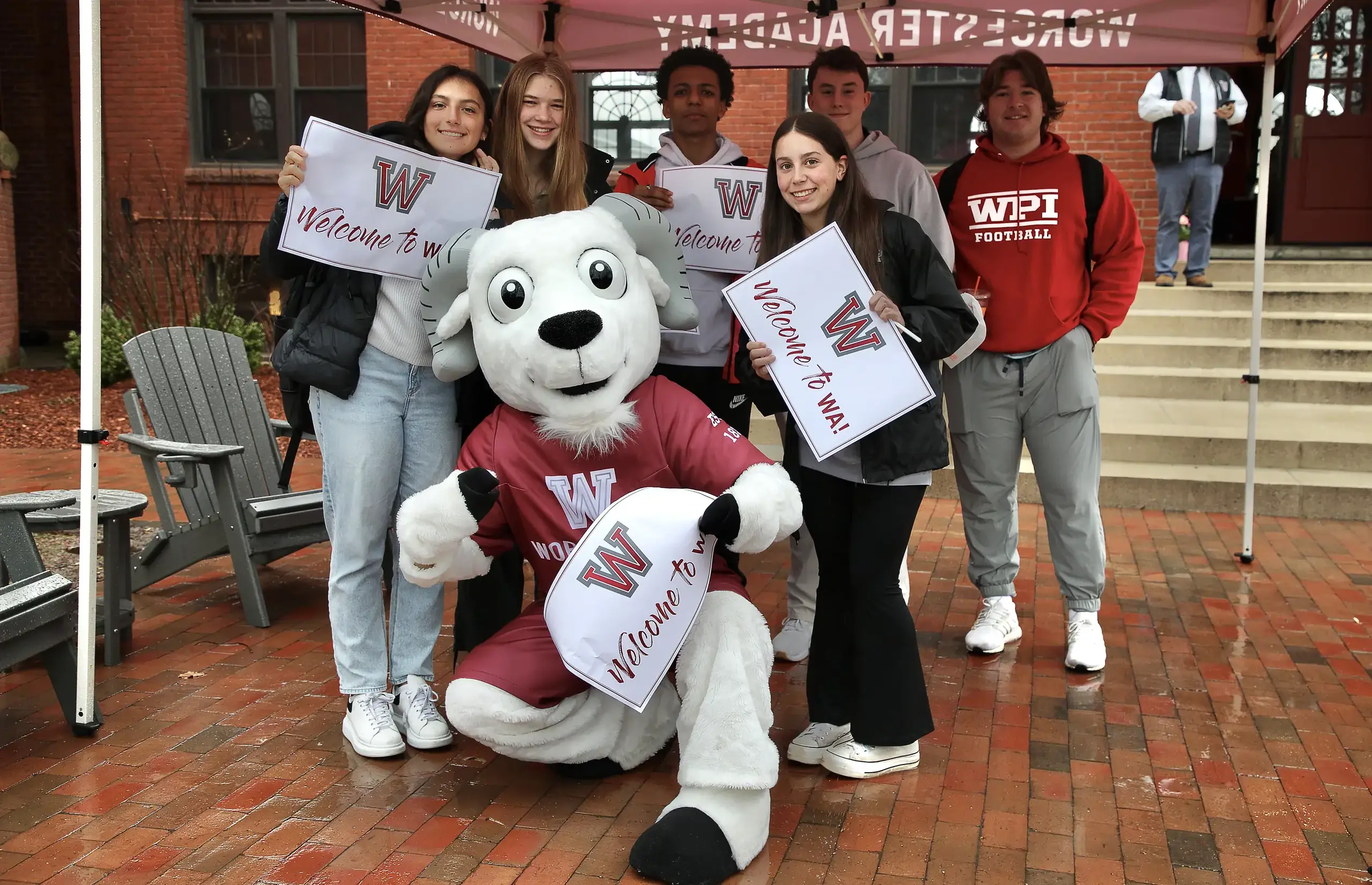 Worcester Academy mascot and students with logo welcome signs.