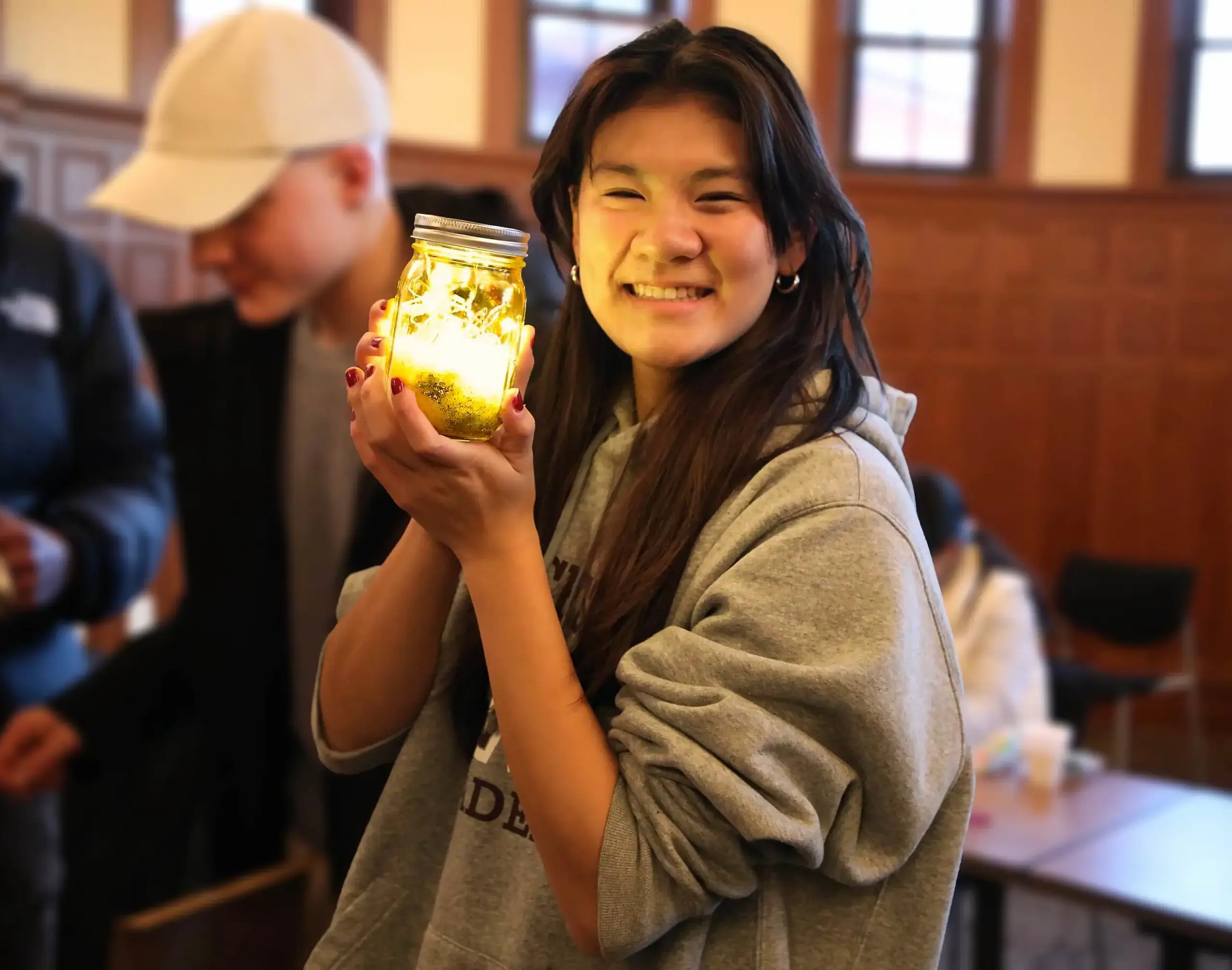 Worcester Academy student holding jar lit with fairy lights