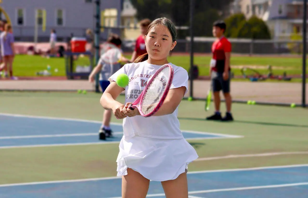 Worcester Academy Student playing tennis.