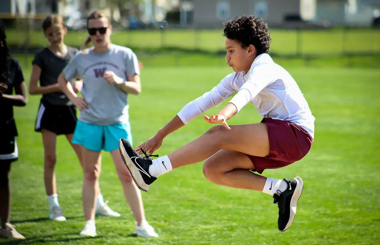 Worcester Academy Student doing long jump.