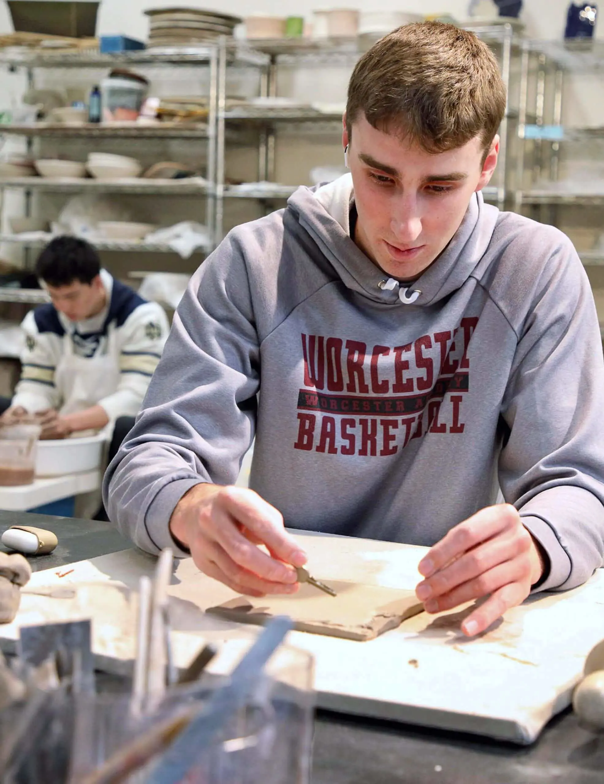 Worcester Academy Upper School student working with clay in a Visual Arts Class.