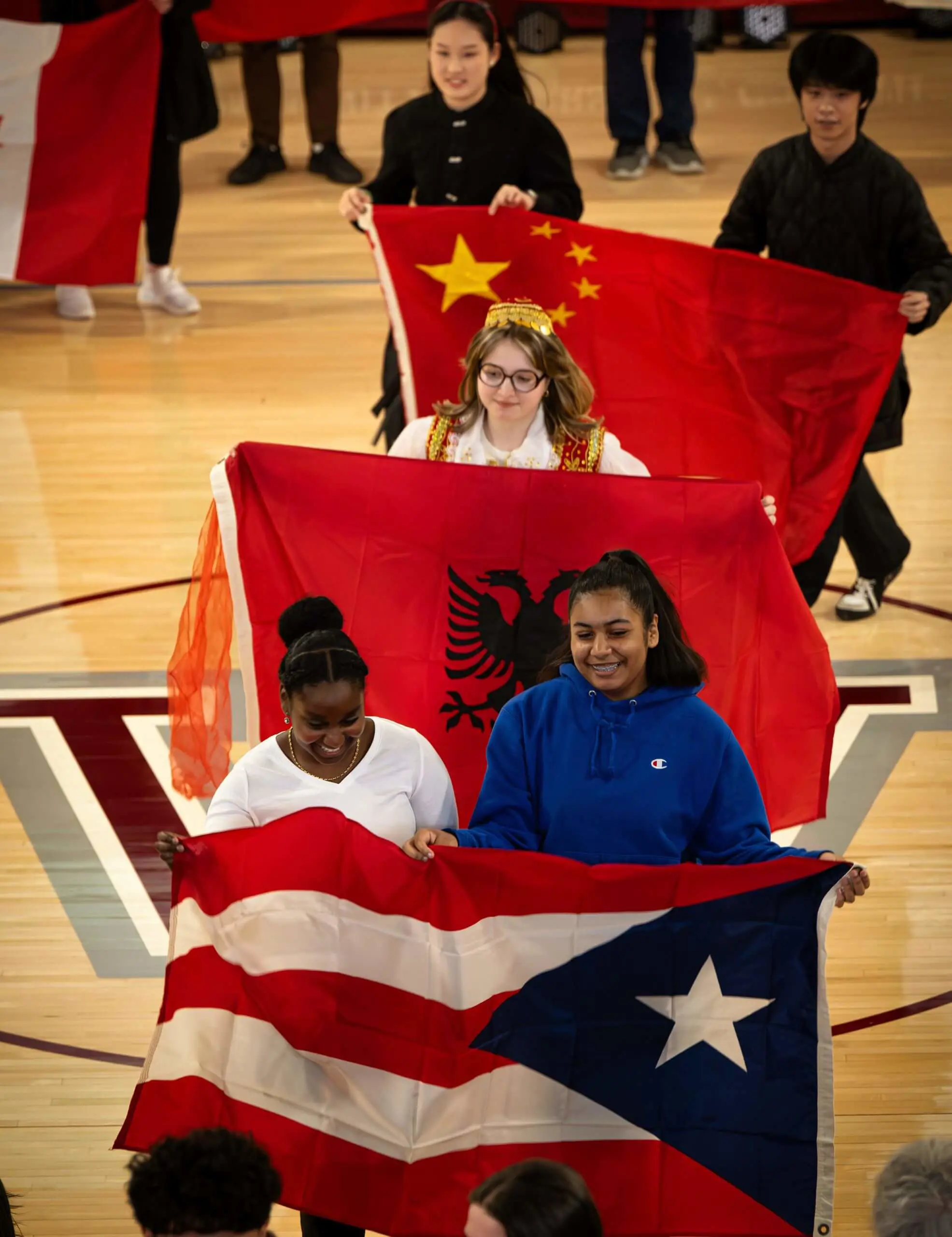 Worcester Academy Upper School Students parading with Flags for International Assembly.