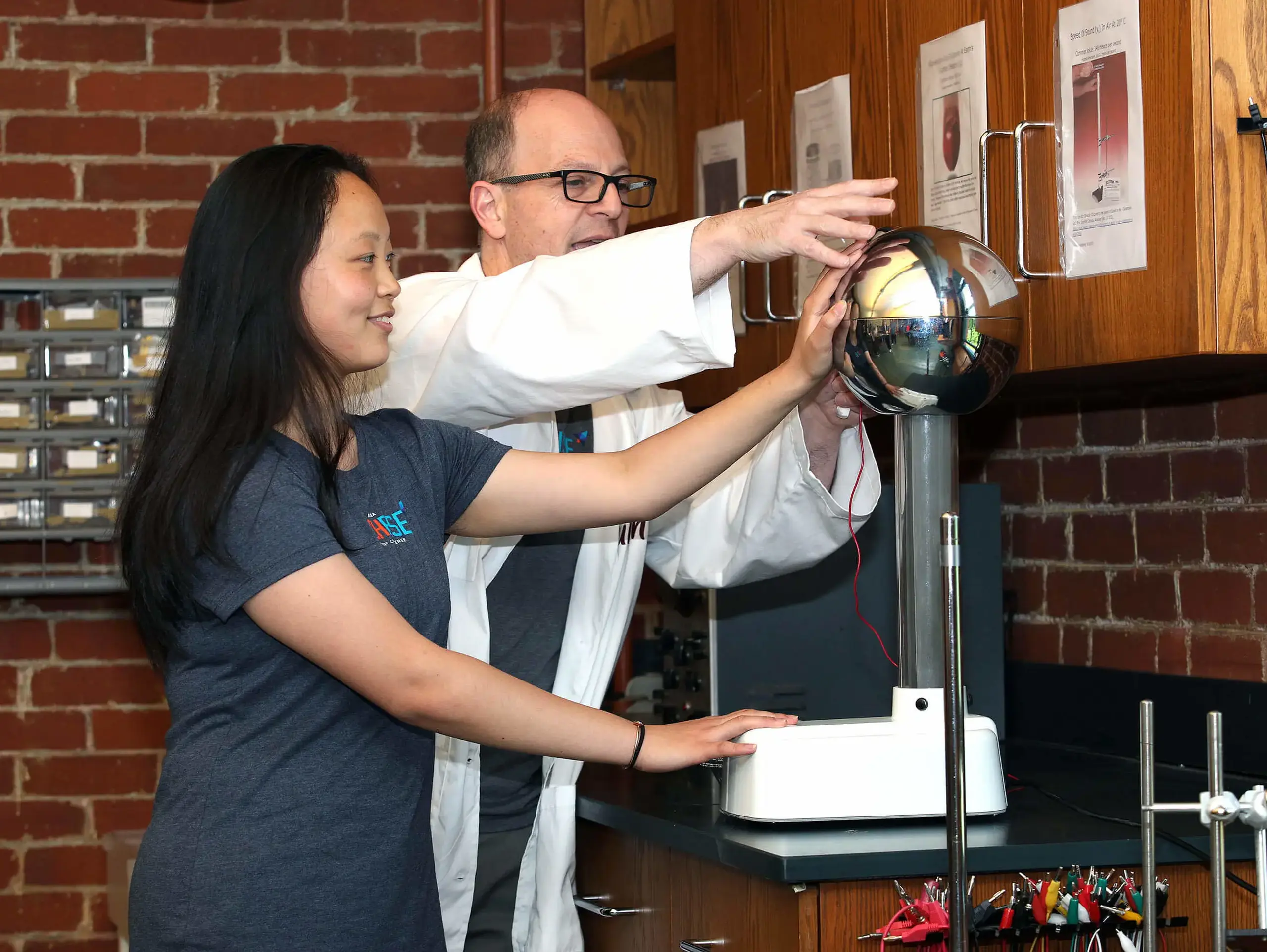 Worcester Academy Upper School student and teacher conducting an experiment in a science class.