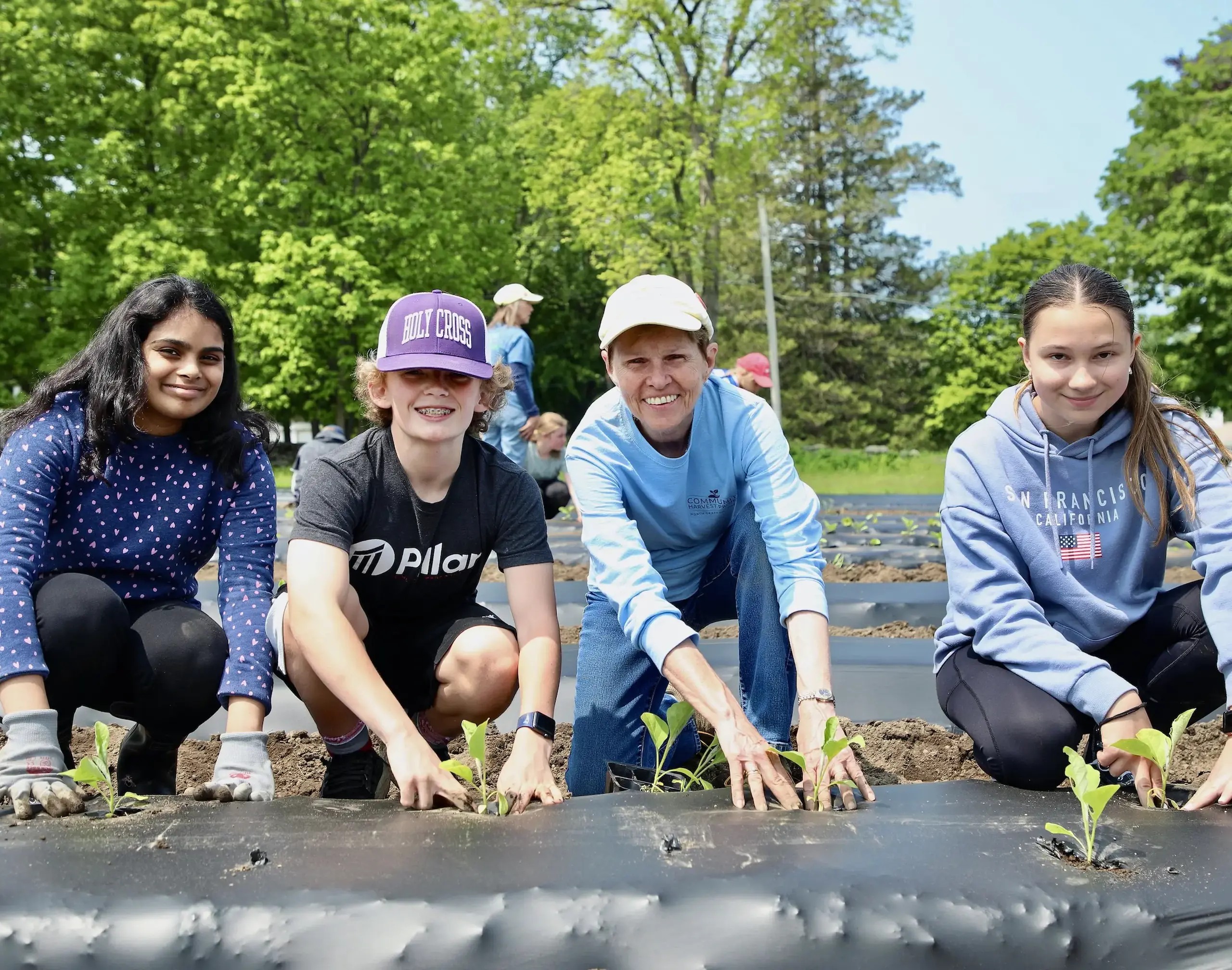 Middle School students planting seedlings.